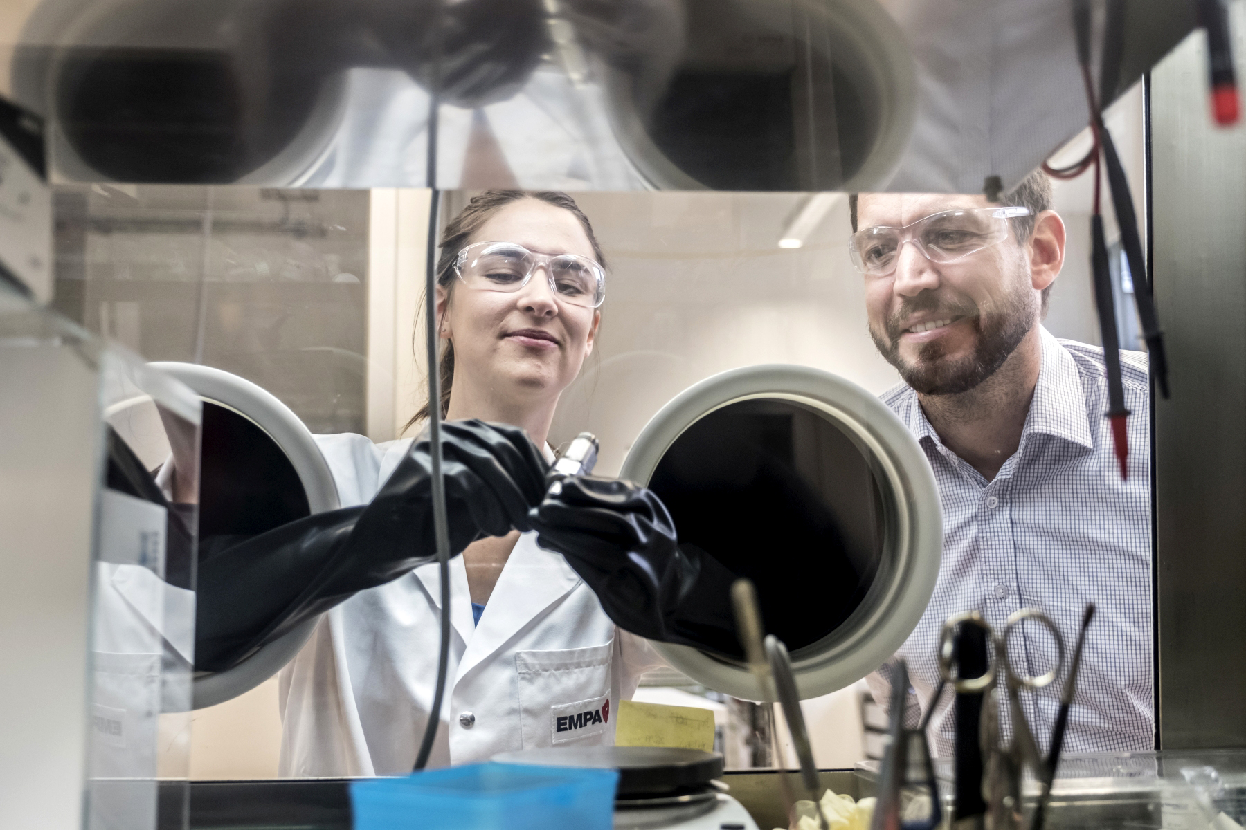 Marie Claude Bay and Corsin Battaglia work in a glove box on the solid state batteries of the future. Marie Claude Bay and Corsin Battaglia work in a glove box on the solid state batteries of the future.